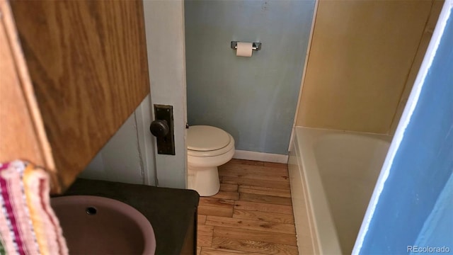 1010 San Juan Ave, Saguache, CO 81149 - bathroom featuring hardwood / wood-style floors, a tub, a shower, and vanity