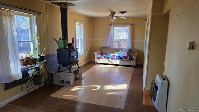 1010 San Juan Ave, Saguache, CO 81149 - bedroom featuring a wood stove, hardwood / wood-style floors, and heating unit