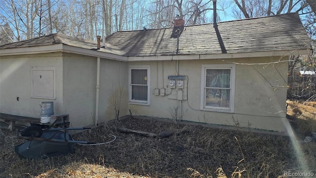 1010 San Juan Ave, Saguache, CO 81149 - view of side of property featuring a shingled roof and a chimney