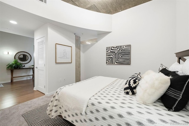 bedroom featuring light colored carpet and a closet