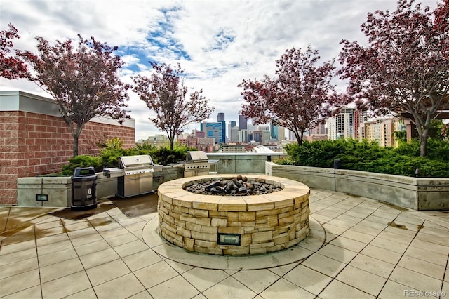 view of patio / terrace featuring area for grilling, an outdoor fire pit, and exterior kitchen