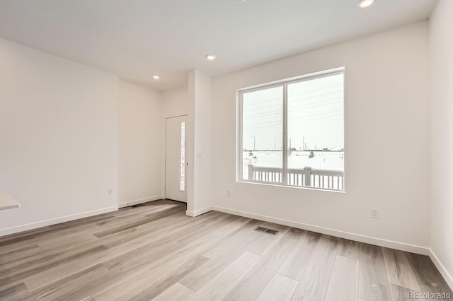 unfurnished room with light hardwood / wood-style floors