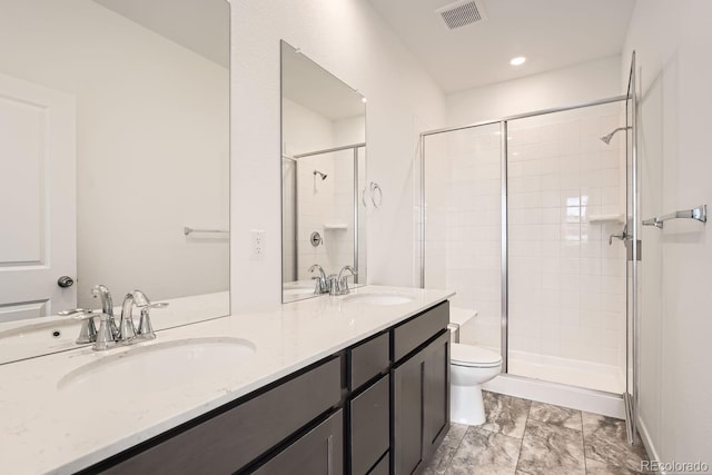 bathroom featuring toilet, walk in shower, and vanity