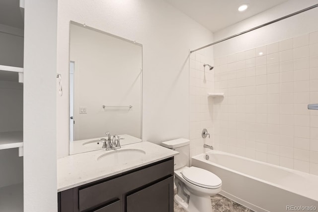 full bathroom featuring toilet, tiled shower / bath combo, tile patterned flooring, and vanity