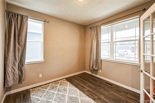833 Vixen Dr, Fort Collins, CO 80524 - empty room with a healthy amount of sunlight and hardwood / wood-style flooring