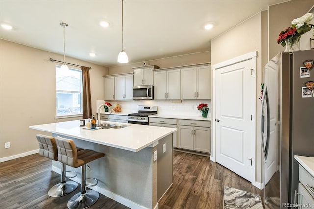 833 Vixen Dr, Fort Collins, CO 80524 - kitchen featuring stainless steel appliances, sink, an island with sink, decorative backsplash, and hanging light fixtures