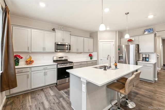 833 Vixen Dr, Fort Collins, CO 80524 - kitchen with sink, a kitchen bar, tasteful backsplash, hanging light fixtures, and appliances with stainless steel finishes