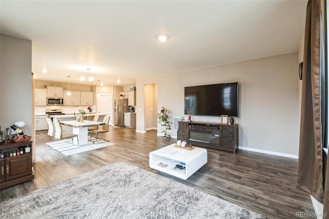 833 Vixen Dr, Fort Collins, CO 80524 - living room with hardwood / wood-style floors and an inviting chandelier