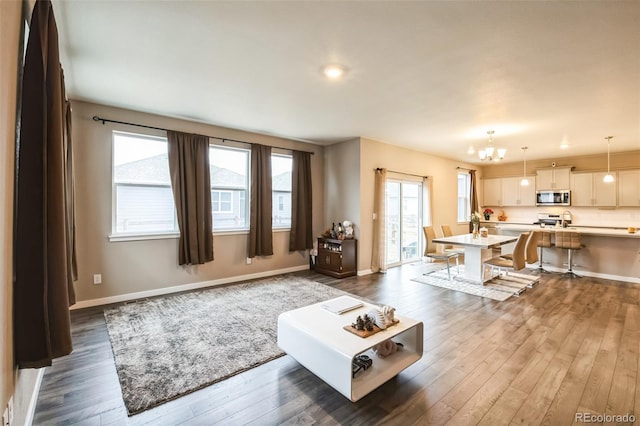 833 Vixen Dr, Fort Collins, CO 80524 - living room with a chandelier and dark hardwood / wood-style floors