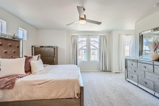 bedroom with light carpet, multiple windows, baseboards, and a ceiling fan