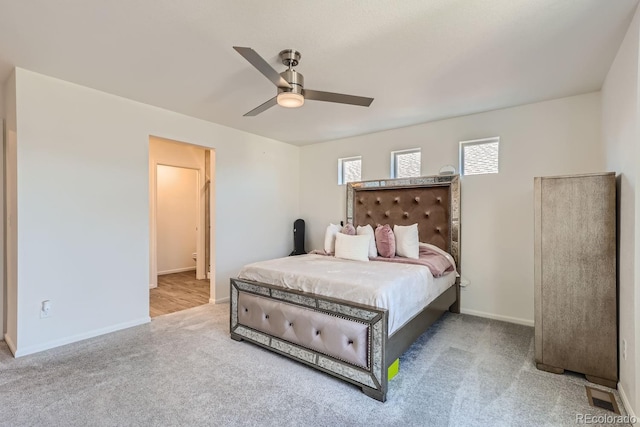 carpeted bedroom with visible vents, ceiling fan, and baseboards