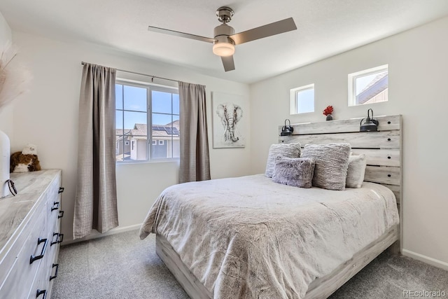 bedroom with light carpet, a ceiling fan, and baseboards