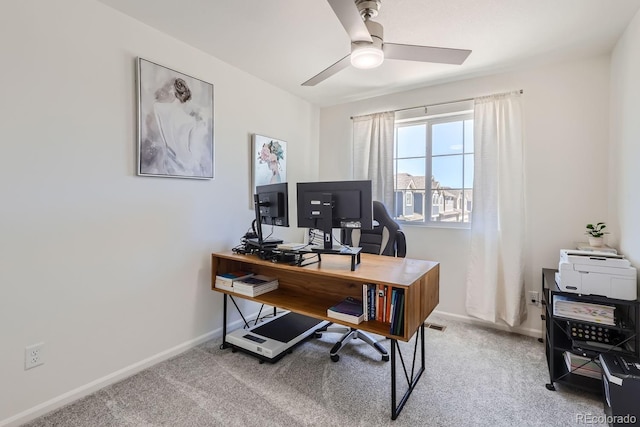 office area with carpet floors, a ceiling fan, and baseboards