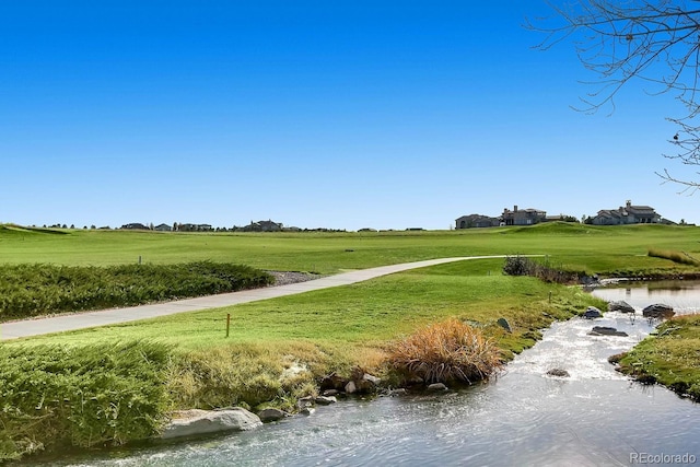 view of community with a rural view and a lawn