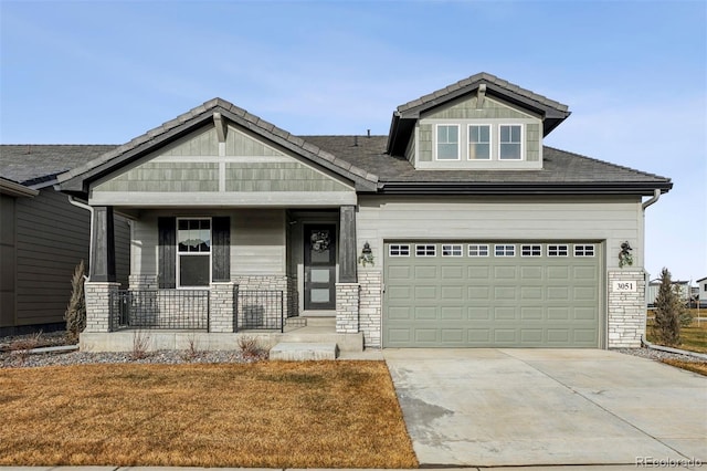 craftsman house with covered porch and a garage