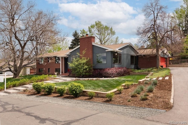 view of front of home featuring a front yard and a chimney