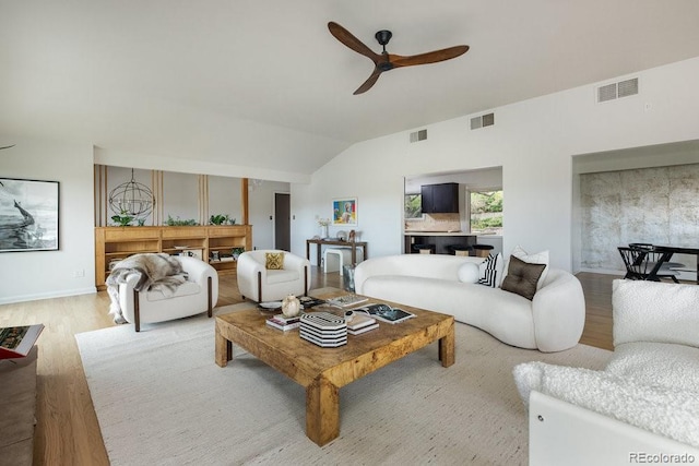 living area with ceiling fan, visible vents, wood finished floors, and lofted ceiling