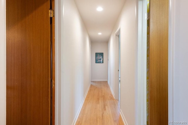 corridor featuring recessed lighting, baseboards, and light wood finished floors