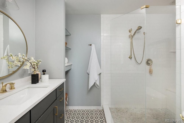 bathroom featuring vanity, baseboards, and walk in shower