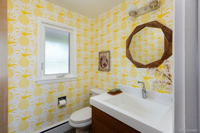 half bath with vanity, toilet, wallpapered walls, and a baseboard radiator