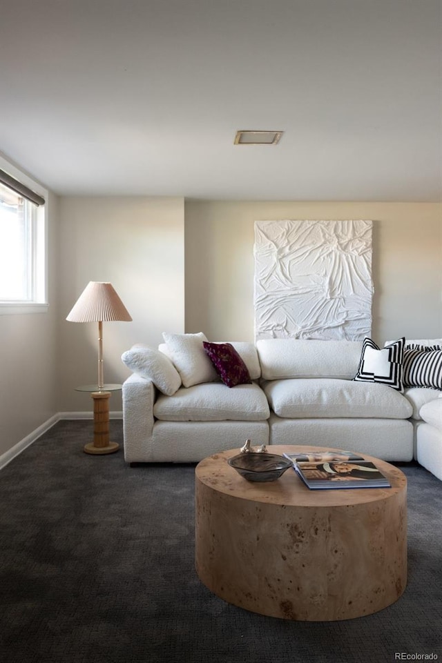 living area featuring baseboards and carpet