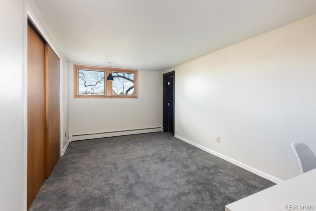empty room featuring baseboards, a baseboard radiator, and carpet
