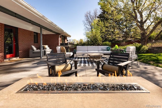 view of patio / terrace with an outdoor living space with a fire pit