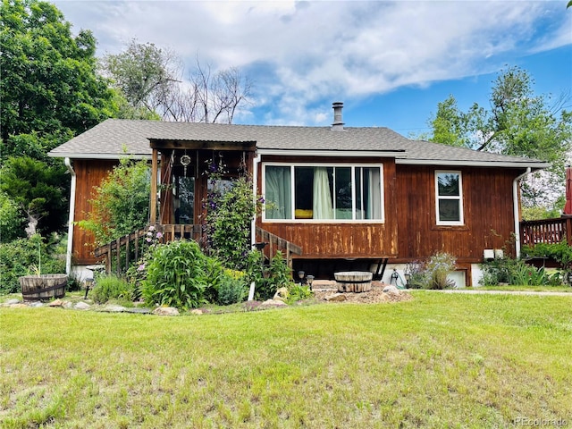 8211 Rocky Mountain Dr, Lakewood, CO 80214 - view of front of house featuring a front lawn and roof with shingles