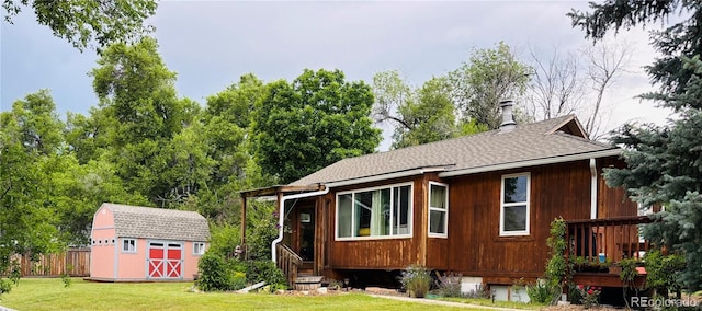 8211 Rocky Mountain Dr, Lakewood, CO 80214 - view of side of home featuring a storage unit and roof with shingles