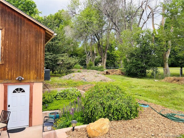 8211 Rocky Mountain Dr, Lakewood, CO 80214 - view of yard featuring view of wooded area