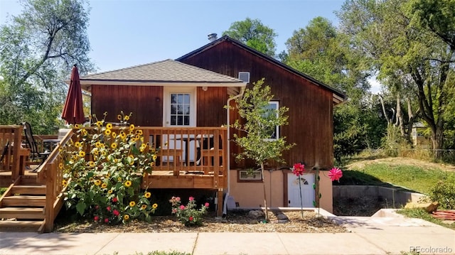 8211 Rocky Mountain Dr, Lakewood, CO 80214 - view of front of house with a wooden deck and roof with shingles