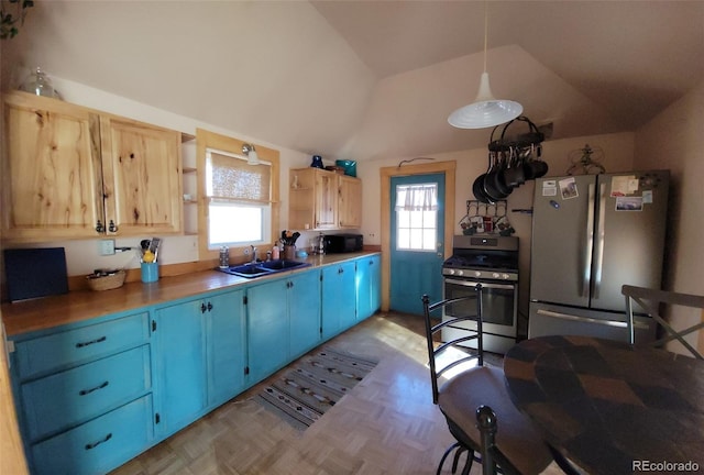8211 Rocky Mountain Dr, Lakewood, CO 80214 - kitchen featuring freestanding refrigerator, gas range, open shelves, blue cabinetry, and black microwave