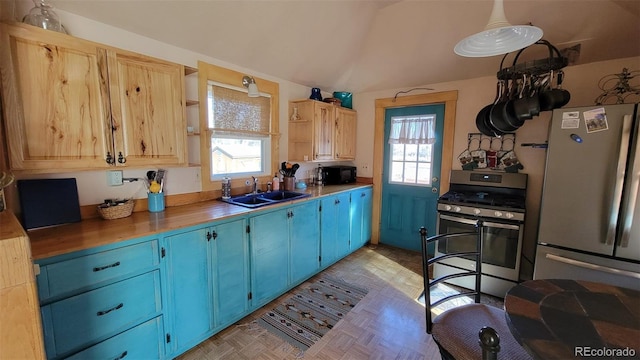 8211 Rocky Mountain Dr, Lakewood, CO 80214 - kitchen featuring stainless steel appliances, open shelves, and blue cabinets