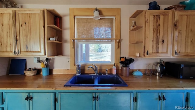 8211 Rocky Mountain Dr, Lakewood, CO 80214 - kitchen featuring open shelves, blue cabinetry, and black microwave