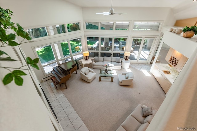 400 S Steele St Unit 13, Denver, CO 80209 - living room with light tile patterned flooring, a high ceiling, ceiling fan, a baseboard heating unit, and light carpet