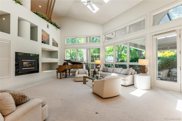 400 S Steele St Unit 13, Denver, CO 80209 - carpeted living room featuring a glass covered fireplace, a ceiling fan, high vaulted ceiling, and tile patterned flooring