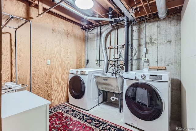 laundry room with washing machine and dryer and sink