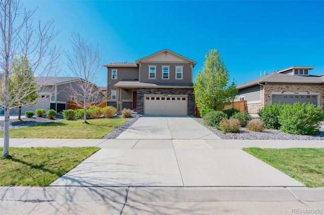 view of front facade with an attached garage, a front lawn, driveway, and stone siding