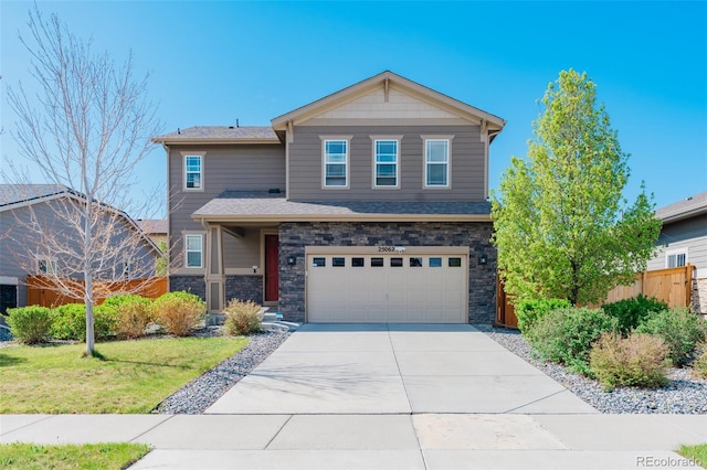 view of front of home featuring concrete driveway, fence, stone siding, and a garage
