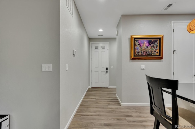 hallway featuring recessed lighting, baseboards, visible vents, and light wood-style flooring
