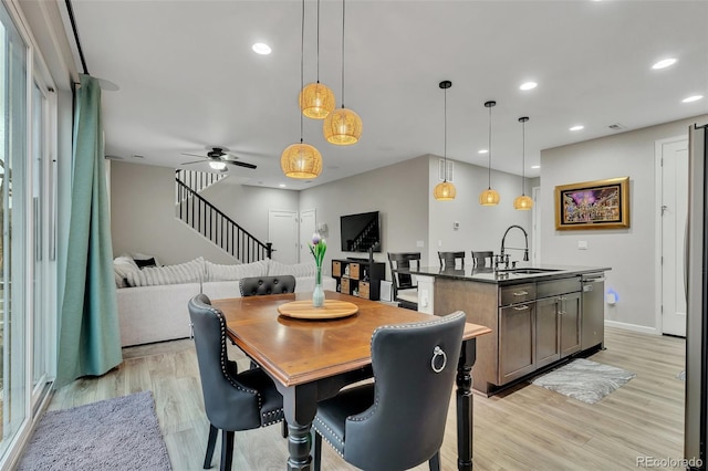 dining room with stairway, ceiling fan, recessed lighting, and light wood-style flooring
