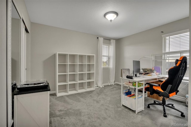 carpeted office featuring baseboards