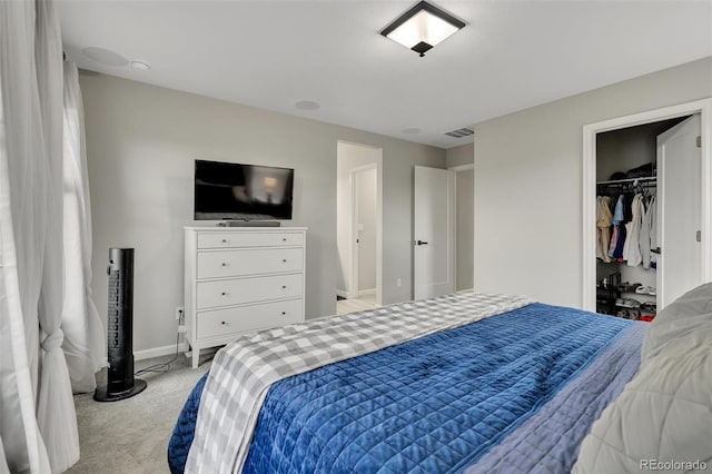 bedroom with visible vents, baseboards, and light carpet