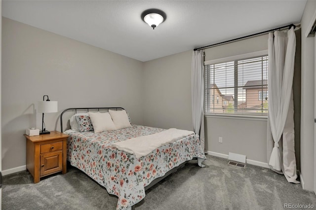 carpeted bedroom featuring baseboards and visible vents