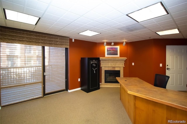 carpeted office with a glass covered fireplace and rail lighting