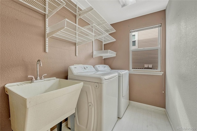 laundry room featuring separate washer and dryer and sink