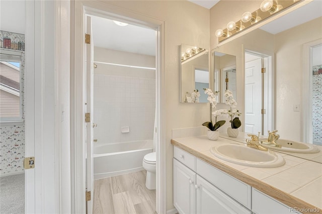 full bathroom featuring vanity,  shower combination, and toilet