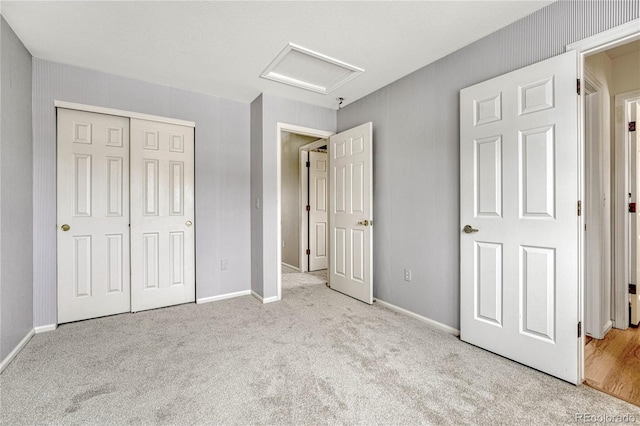 unfurnished bedroom featuring light colored carpet and a closet