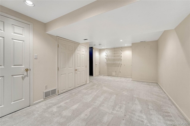 basement featuring light colored carpet