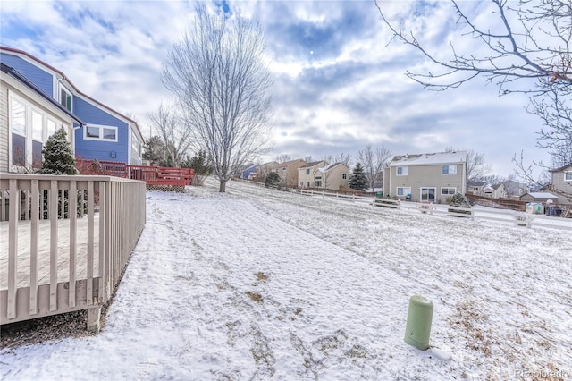 snowy yard featuring a deck